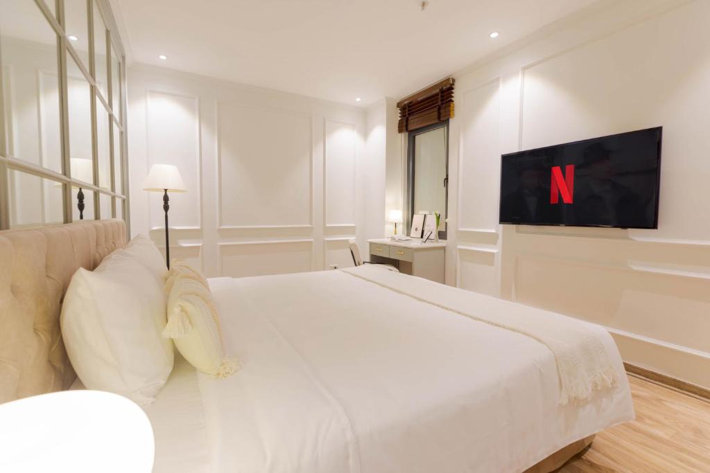 Postel nebo postele na pokoji v ubytování Keypad Hotel - Nhân Hòa