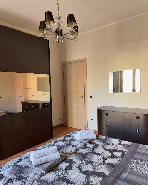 a bedroom with a large bed with two towels on it at Appartamenti Estivi in Cirò Marina