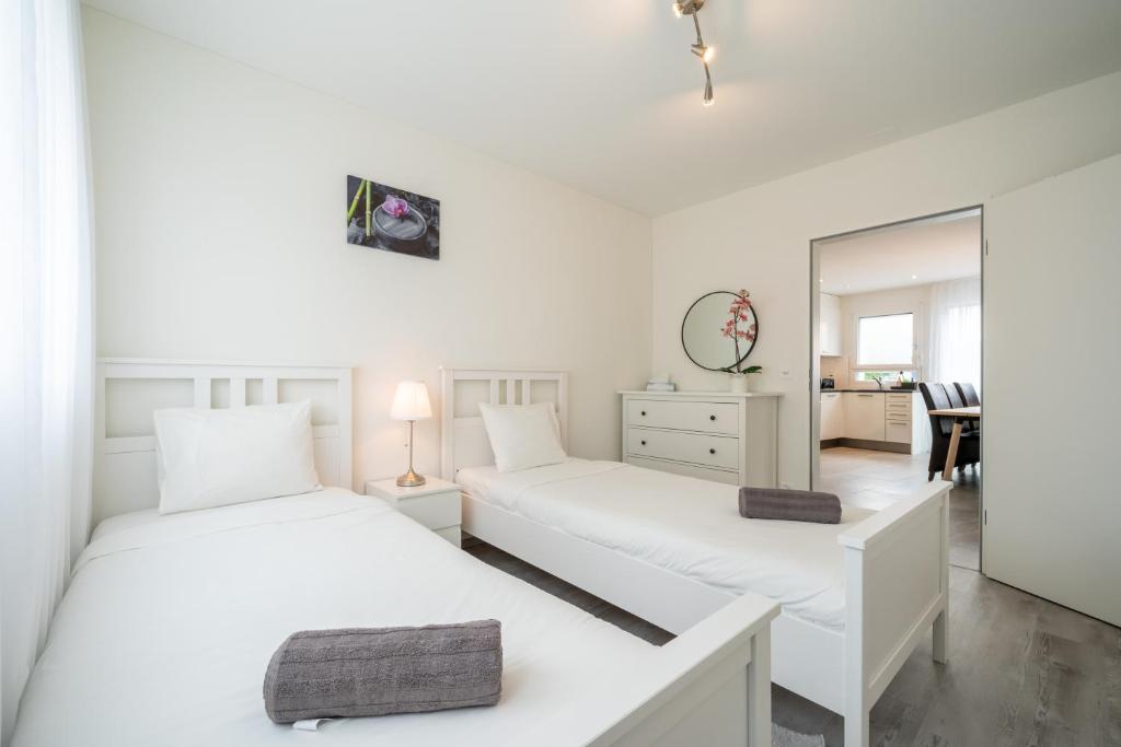 Postel nebo postele na pokoji v ubytování Swiss Suites