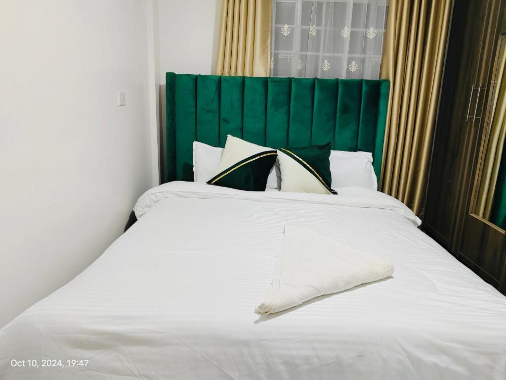 Ένα ή περισσότερα κρεβάτια σε δωμάτιο στο Rispers Homes Nanyuki