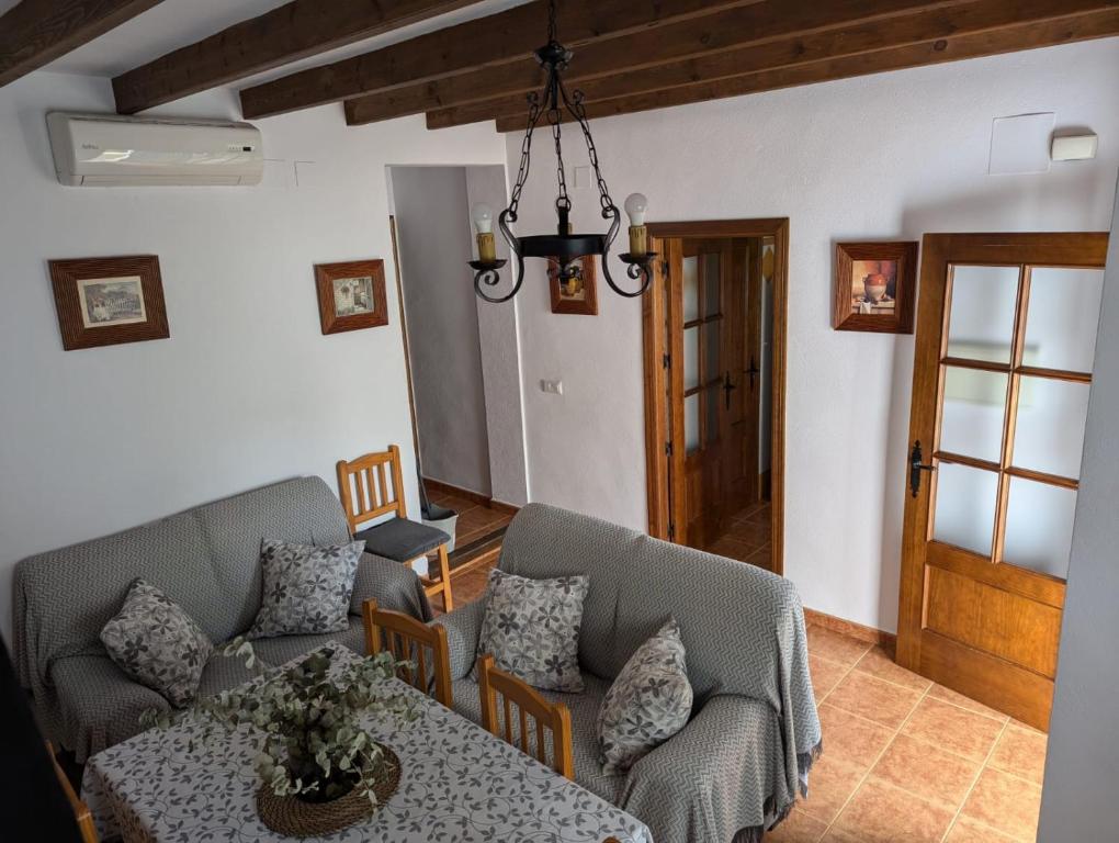 a living room with a couch and chairs and a table at Casa Corredera in Cumbres Mayores