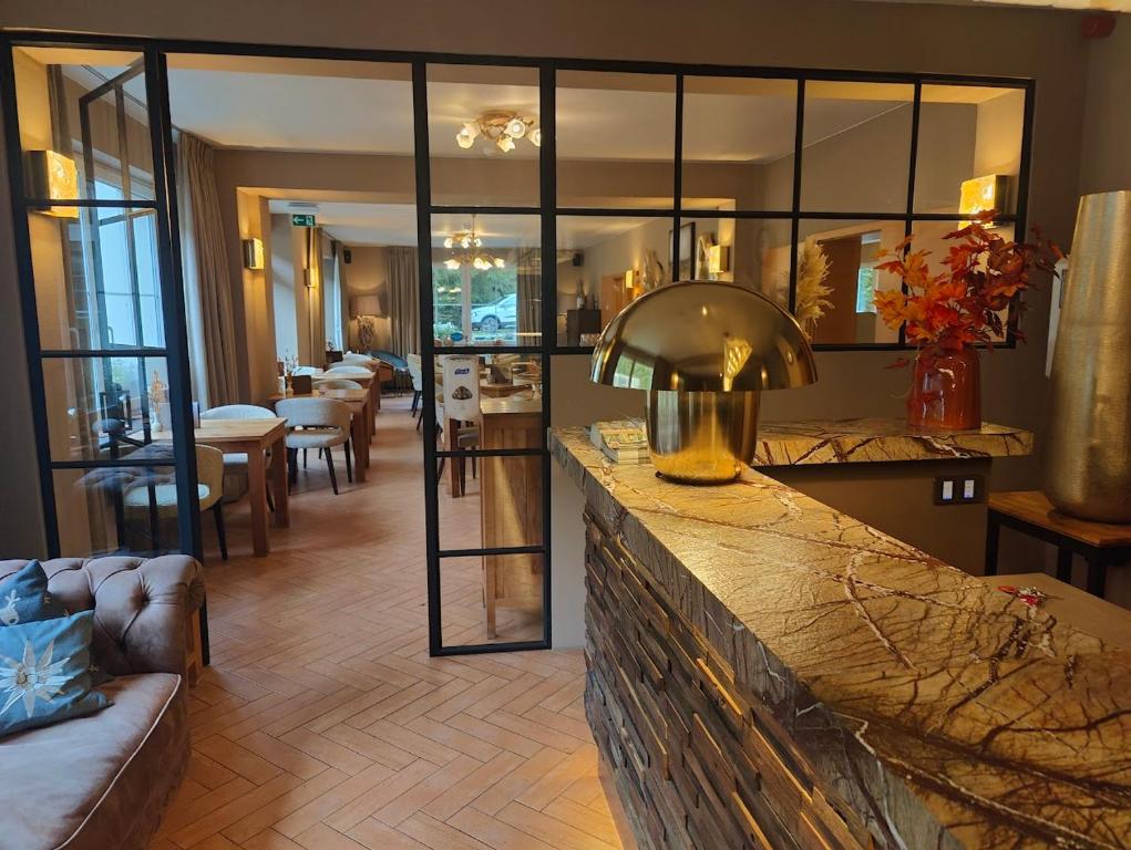 a living room with a couch and a table with chairs at Cocoon Hotel Belair in Bourscheid