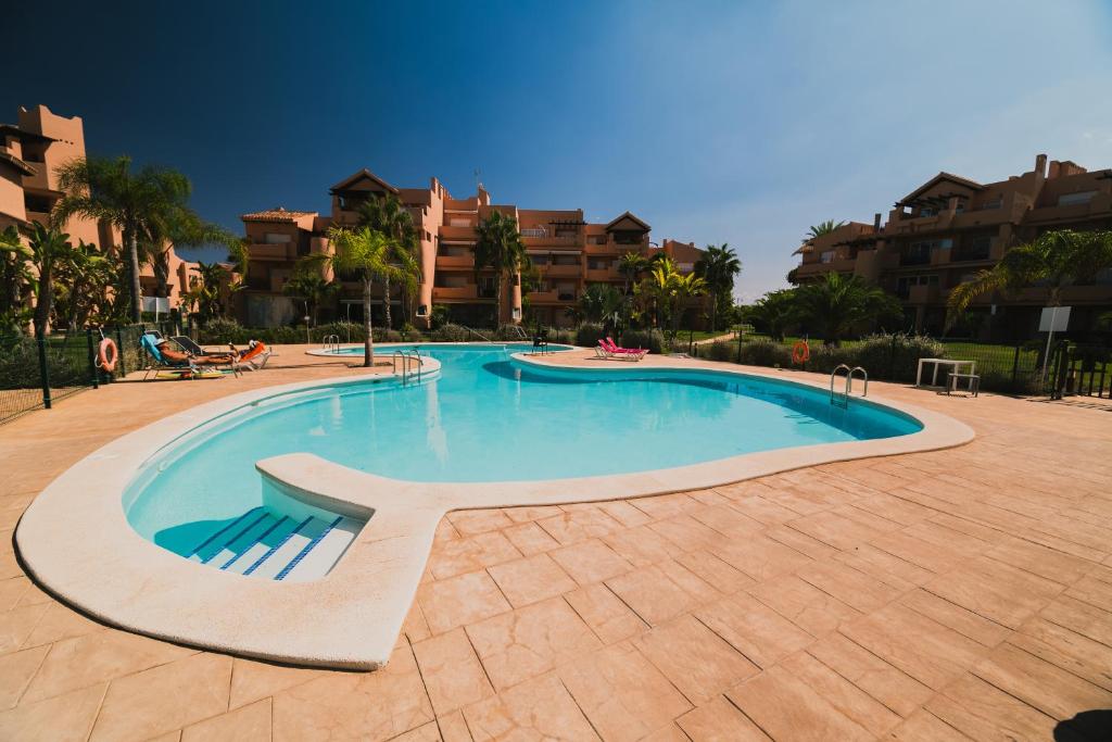 a swimming pool in the middle of a resort at Bonsai in Murcia