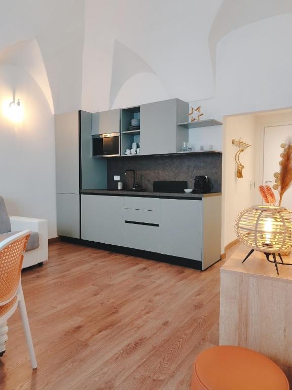 a kitchen with white and black cabinets in a room at La Maddalena Apartment in Bordighera