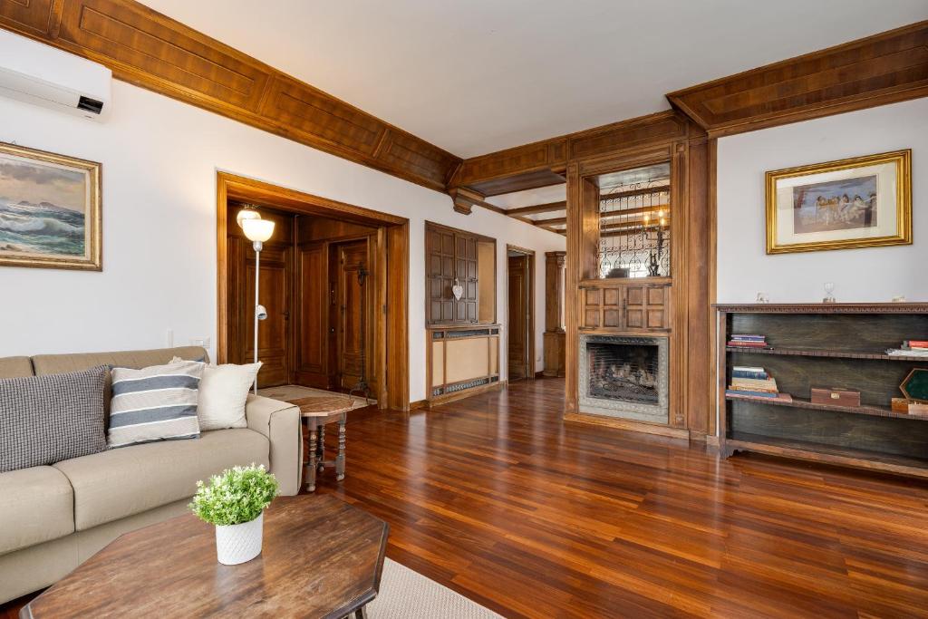 un soggiorno con divano e camino di Elegante appartamento 130mq in stile classico a Roma