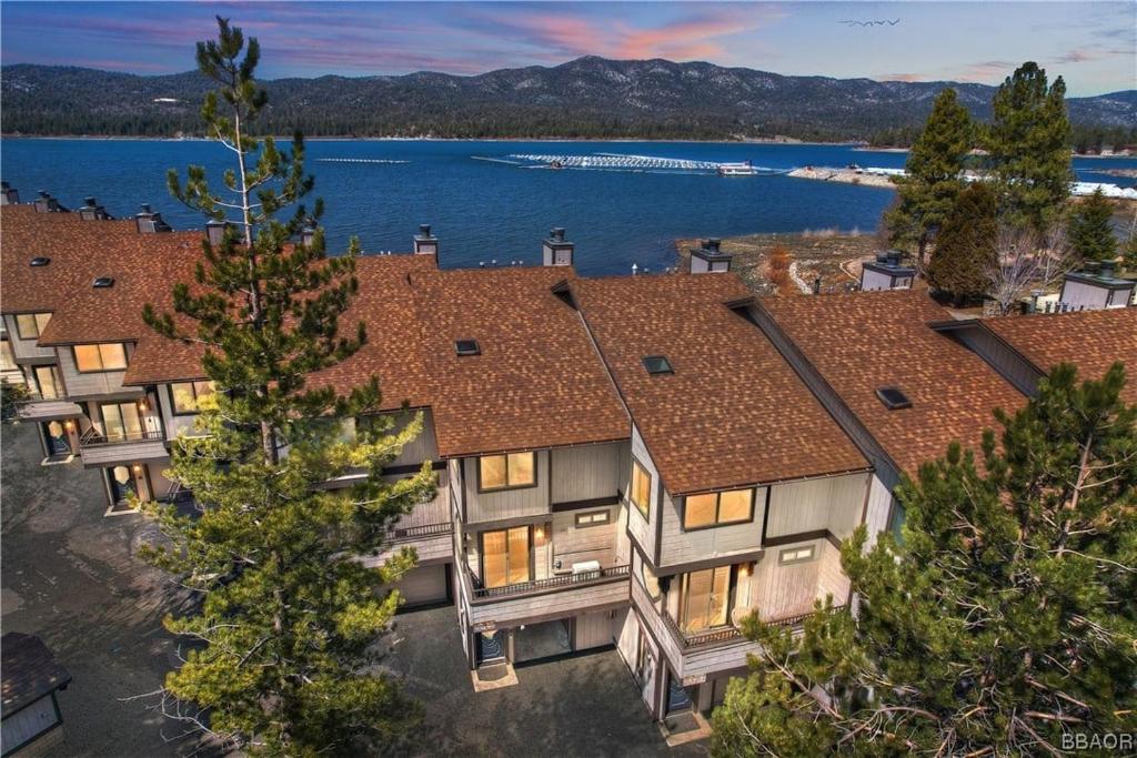 an aerial view of a house with a lake at Shores Lakefront Condo - Walk to Village, Lake Views, Deck with BBQ in Big Bear Lake