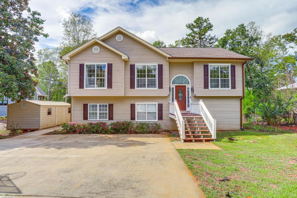 a house with a porch and a driveway at Lakefront Home with Private Boat Dock on Lake Lanier in Murrayville