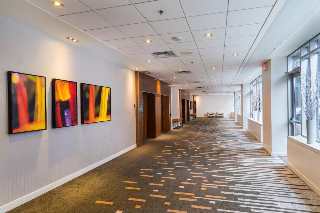 a hallway of an office with paintings on the walls at Delta Hotels by Marriott Ottawa City Centre in Ottawa