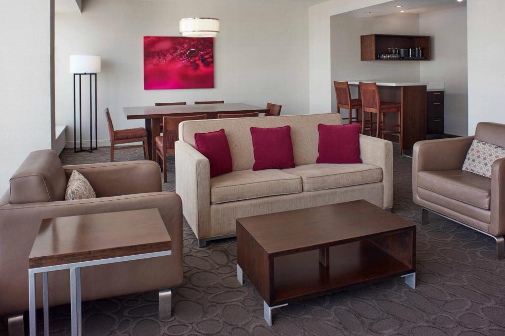 a living room with a couch and chairs and a table at Delta Hotels by Marriott Ottawa City Centre in Ottawa