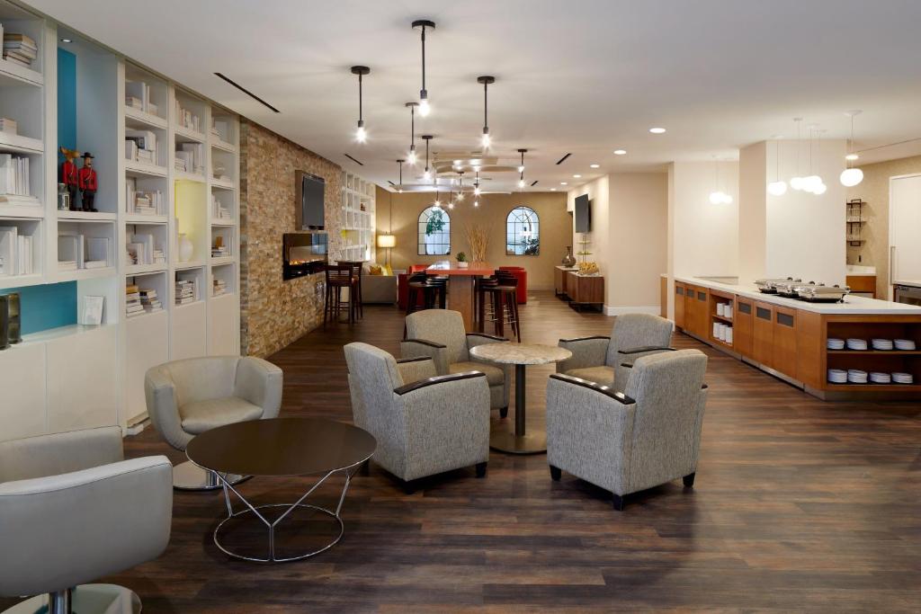 a waiting room with chairs and a table and a counter at Delta Hotels by Marriott Ottawa City Centre in Ottawa