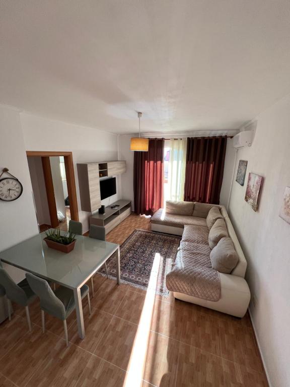 a living room with a couch and a table at Elbasan center apartment in Elbasan