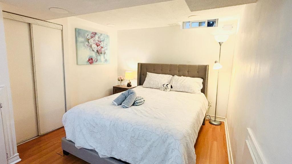 a small bedroom with a bed in a room at Cozy Walkout Basement with Tranquility in Toronto