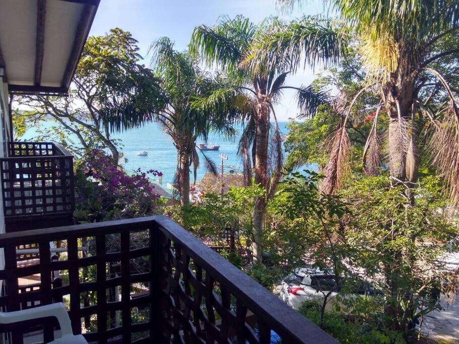 a balcony with a view of the ocean and palm trees at 8 - Studio Vista Mar - Morada do Ganso in Bombinhas