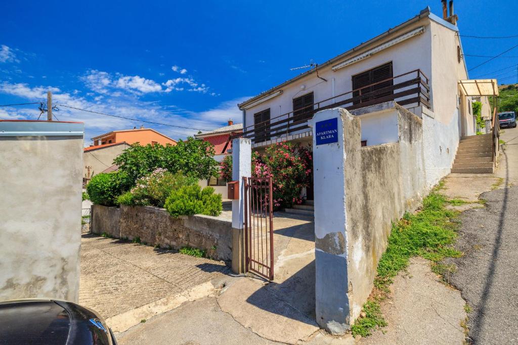 a building with a gate next to a street at Apartment Klara in Senj
