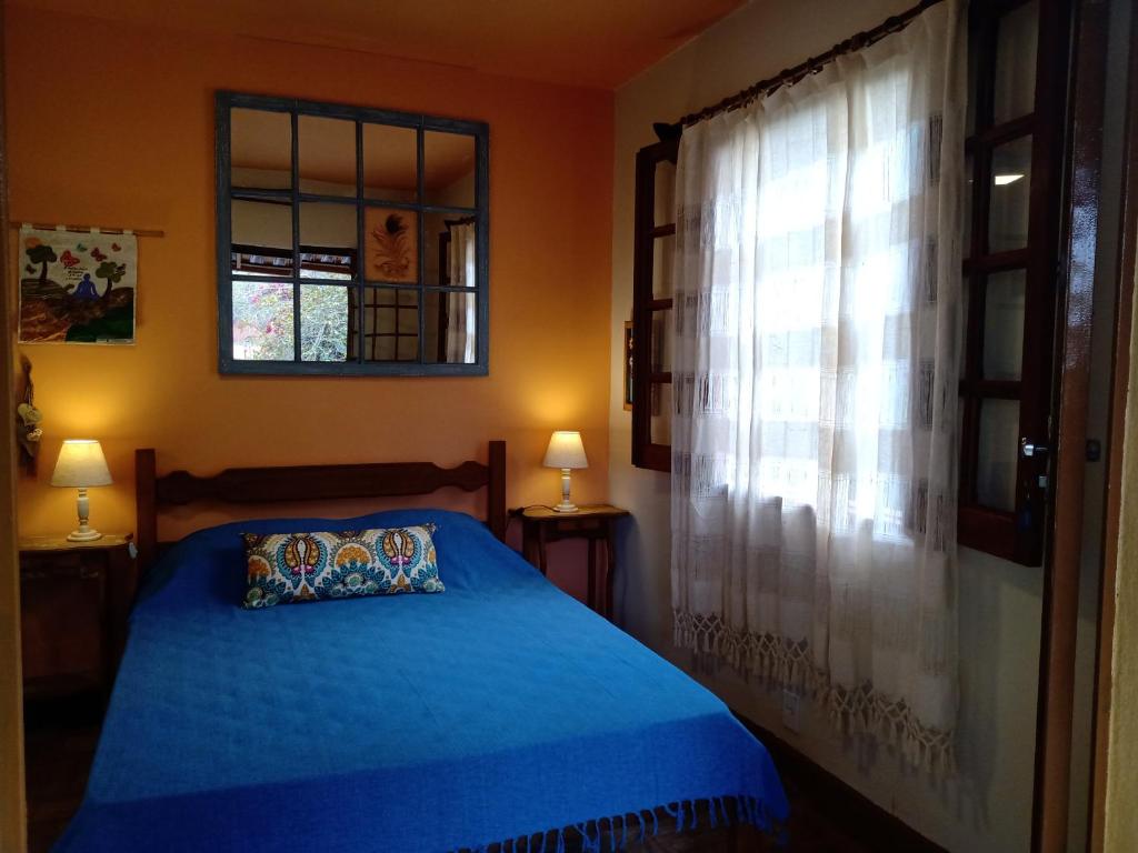 Ένα ή περισσότερα κρεβάτια σε δωμάτιο στο Pousada Santa Martha - Chalé - Entre Rios de Minas