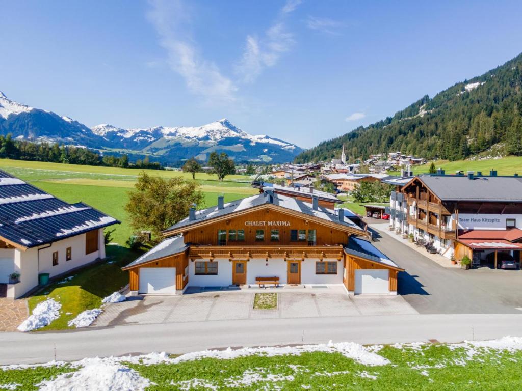 an aerial view of a building with mountains in the background at Maxima II - Ski in - Ski Out in Flecken