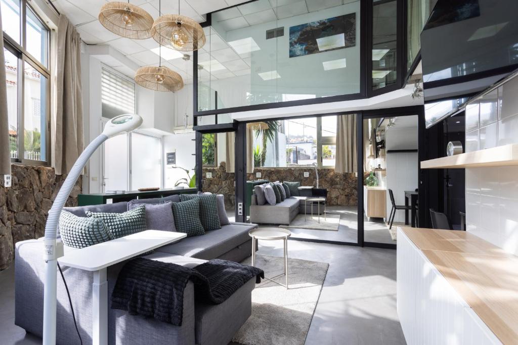 a living room with a couch and a table at OkStay Loft Victoria Top Tenerife in La Victoria de Acentejo