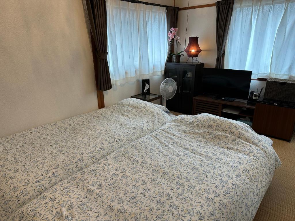 Postel nebo postele na pokoji v ubytování Guest House "Ro"kumano