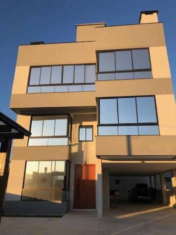 a large building with a lot of windows at Residencial ISL - Praia da Pinheira SC in Palhoça