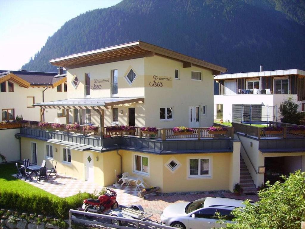 a large building with cars parked in front of it at Holiday Apartment, Apartment Melanie in Niederthai