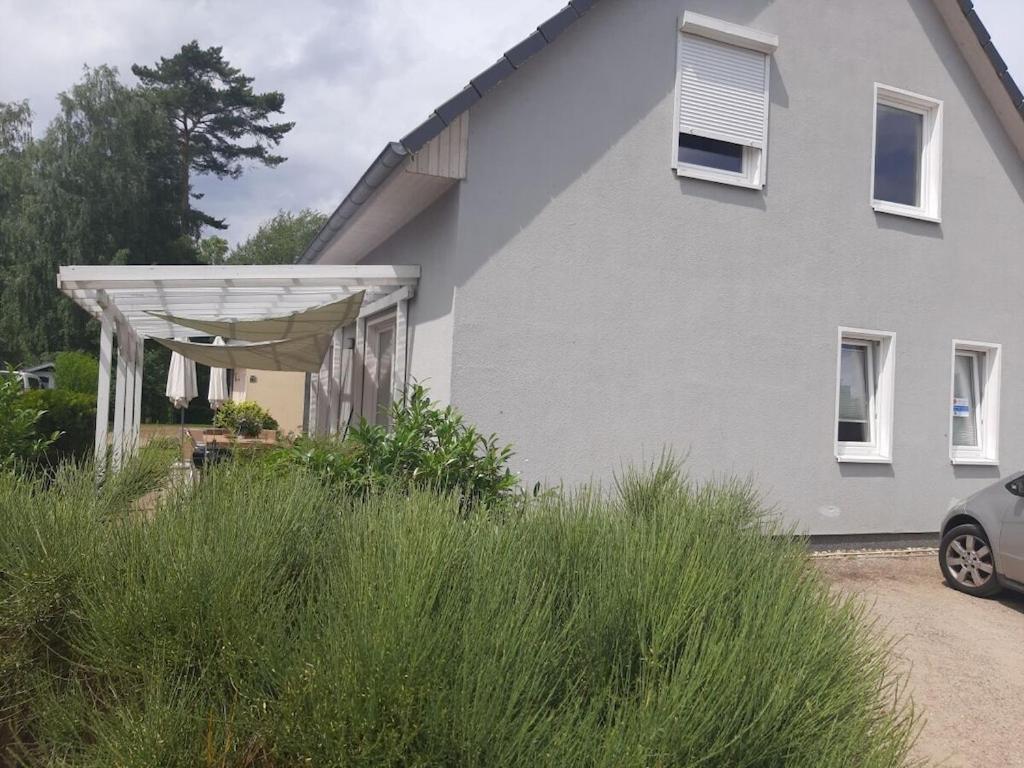 a white house with awning in front of it at "thousand lakes" Comfortable holiday residence in Marienfelde