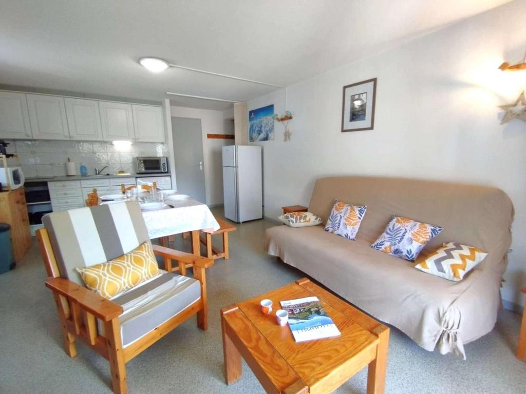 a living room with a couch and a table at Charmant T3 6 pers, terrasse sud, parking, centre St Lary Soulan - FR-1-457-357 in Saint-Lary-Soulan