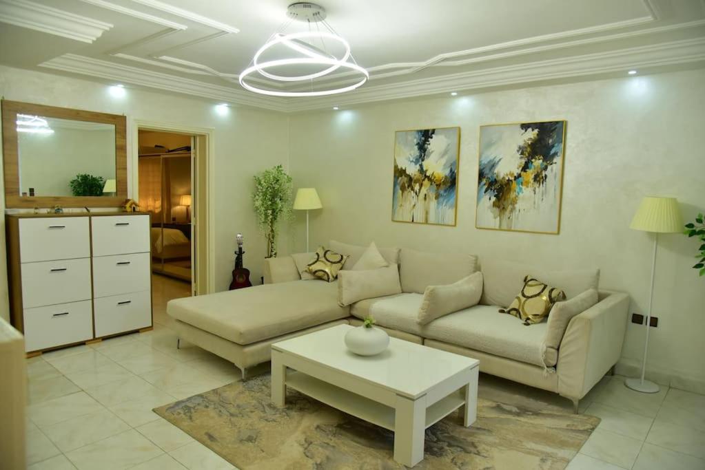 Hotel Petit paradis au cœur de Rabat, jardin privatif, a living room with a couch and a table at Petit paradis au cœur de Rabat, jardin privatif in Rabat