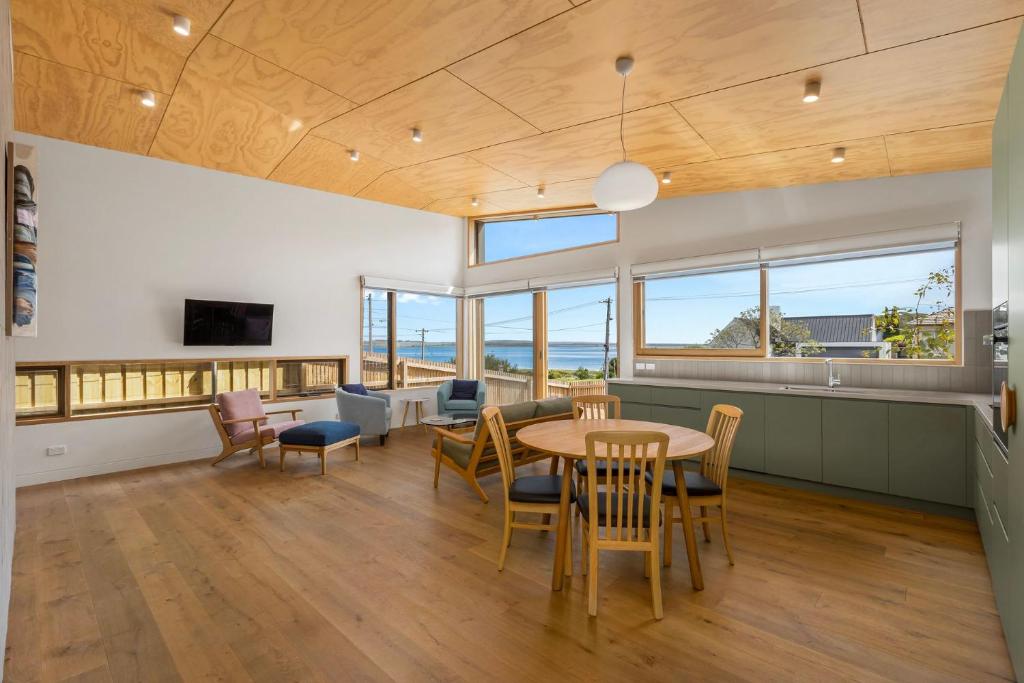 a kitchen and dining room with a table and chairs at Swan's Reach in Queenscliff