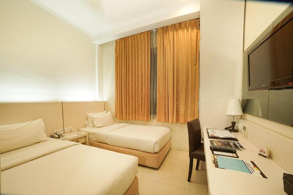 TV a/nebo společenská místnost v ubytování Ros-In Hotel