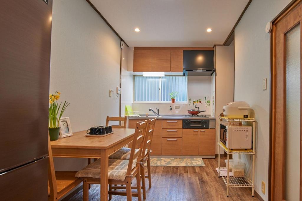 a kitchen with a table and chairs in a room at Near Osaka Castle entire villa at Kyobashi Station in Osaka