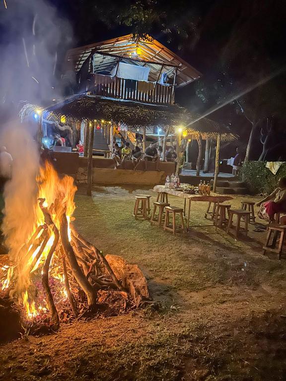 a bonfire in front of a restaurant at night at Eco Lodge Safari in Karuwalagaswewa