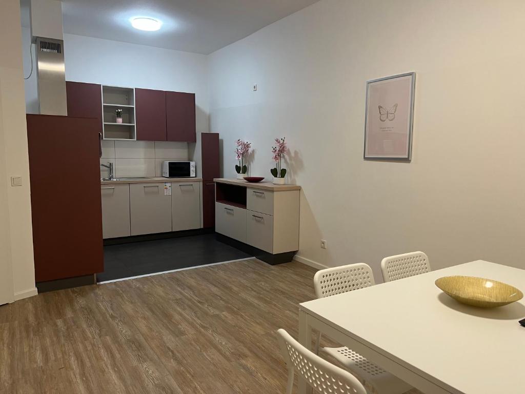 a kitchen with a table and chairs in a room at T&K Apartments- 2 Room Apartment - Heart of Solingen - Private parking in Solingen