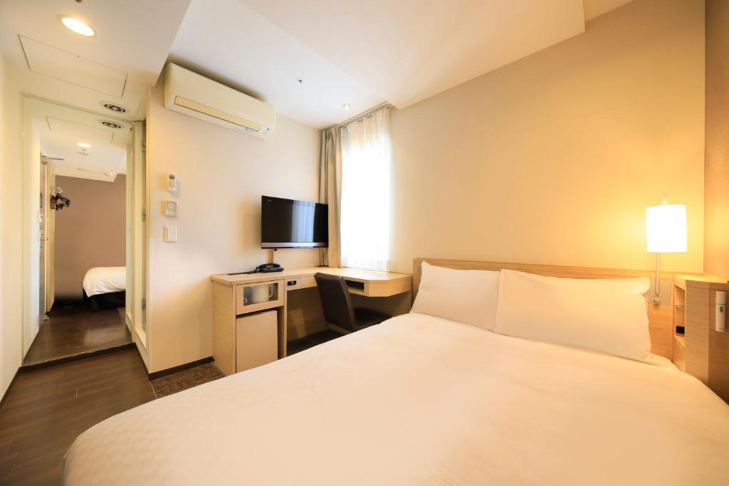 Postel nebo postele na pokoji v ubytování Via Inn Akihabara