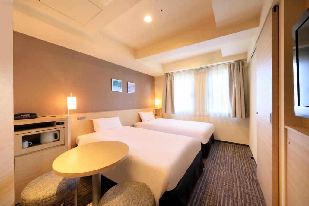 Postel nebo postele na pokoji v ubytování Via Inn Akihabara