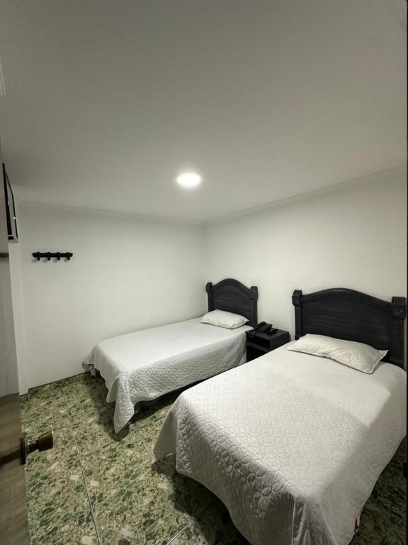 Postel nebo postele na pokoji v ubytování Hotel Nuevo Horizonte E.M.J