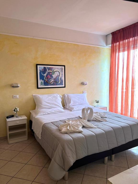 Postel nebo postele na pokoji v ubytování Hotel Naica