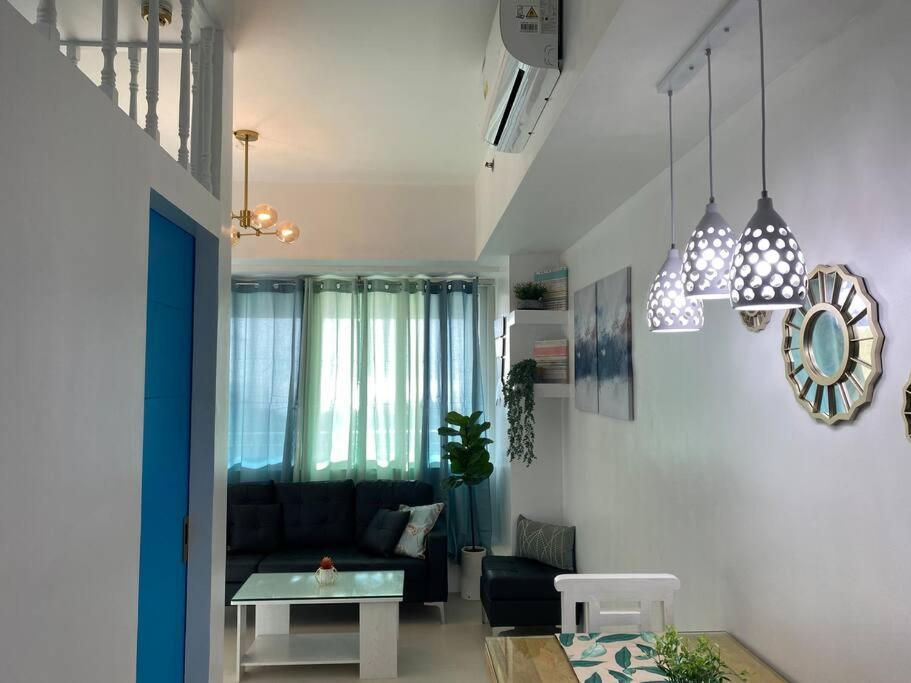 a living room with a couch and a table at 2 Bedroom Mactan Beach Condo, La Mirada Residences in Lapu Lapu City