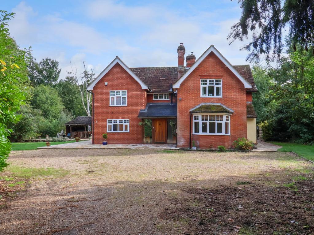 a large red brick house with a large yard at Brook Lodge in Ipswich