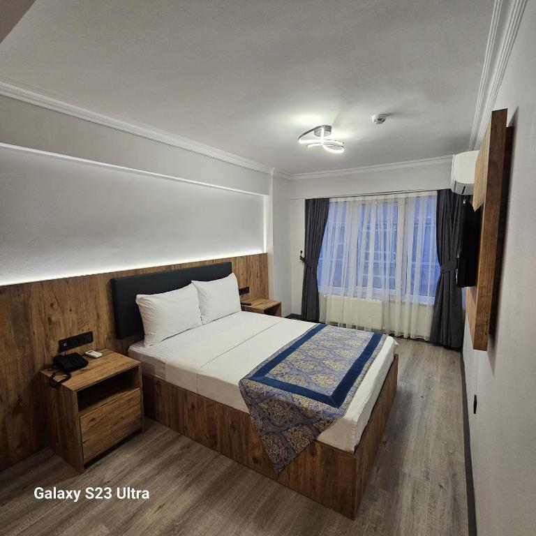a hotel room with a bed and a window at Hatay Hotel in Istanbul