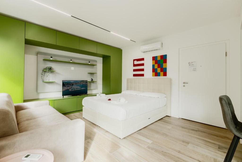 a living room with a white couch and green walls at Home Sofia Room 5, for Couples -By EasyLife Swiss in Lugano
