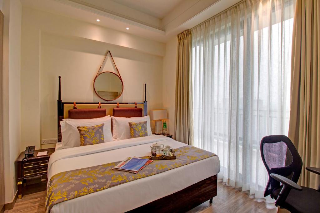 Postel nebo postele na pokoji v ubytování Rhythm Gurugram Hotel & Suites, Sohna Road