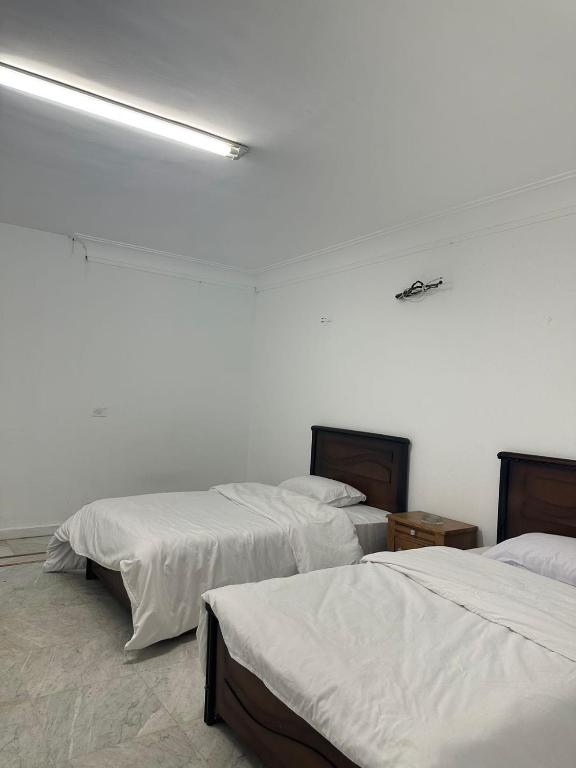 Postel nebo postele na pokoji v ubytování QinFu HOTEL