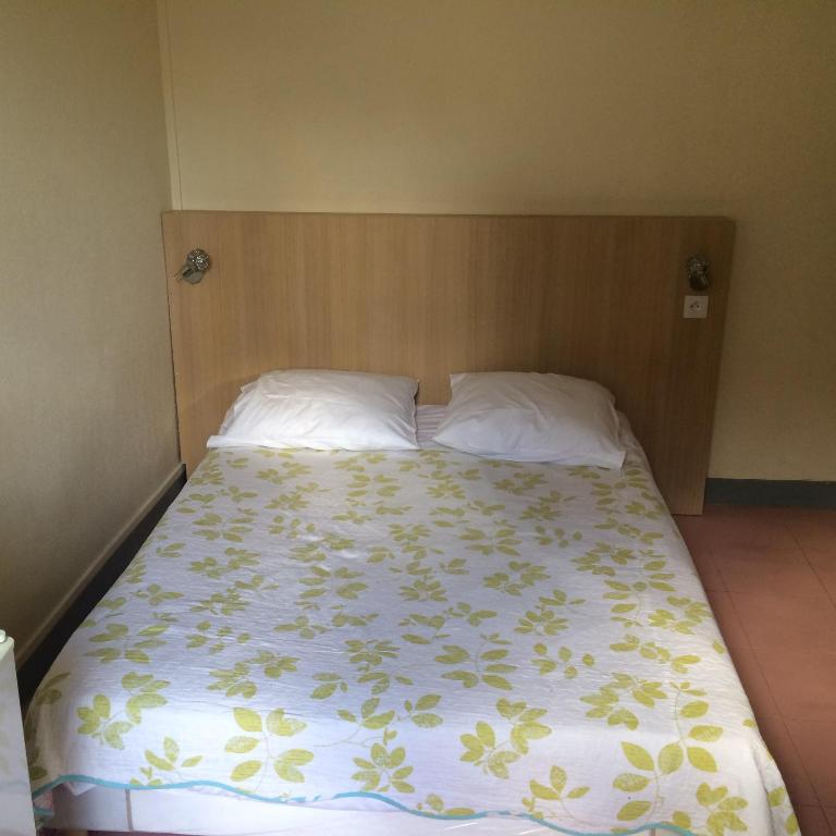 a bedroom with a bed with a floral bedspread at Au Royal Mad in Paris
