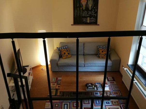 a living room with a couch in a room at Triplex près de la Grand-Place in Brussels