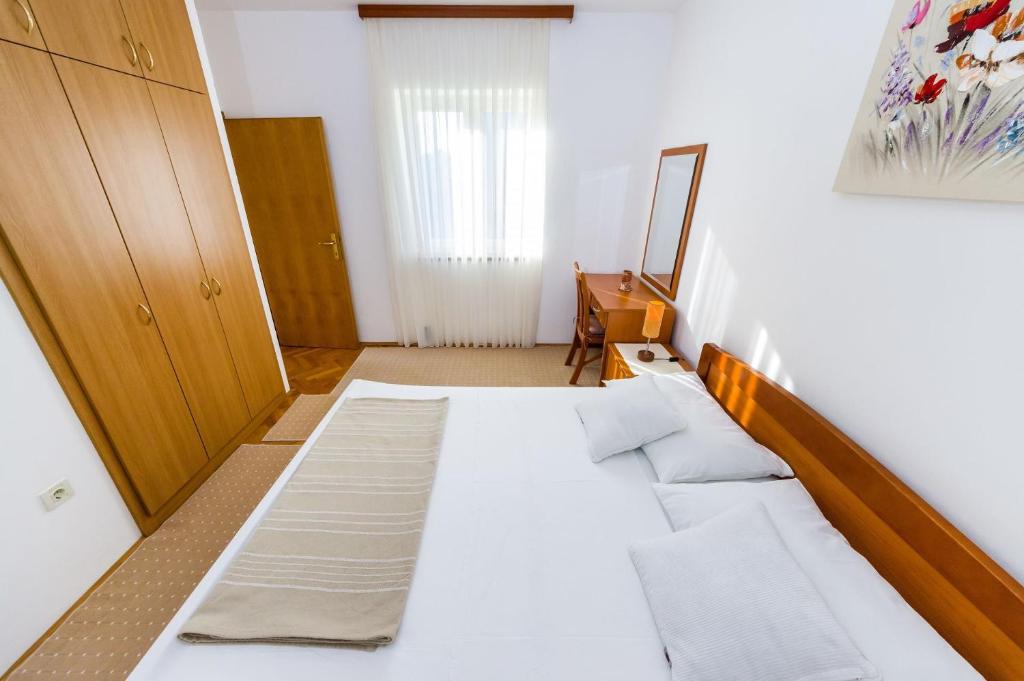 Postel nebo postele na pokoji v ubytování Apartments Cloe