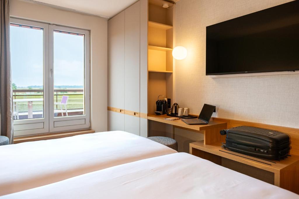 Postel nebo postele na pokoji v ubytování Hotel L'Europe