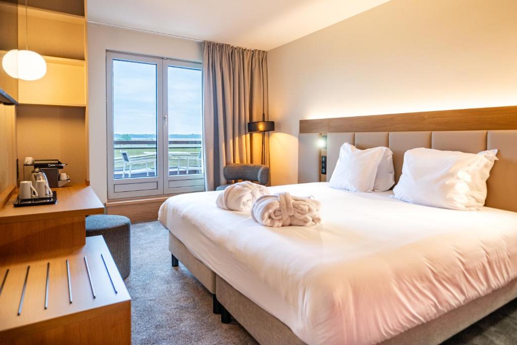 Postel nebo postele na pokoji v ubytování Hotel L'Europe