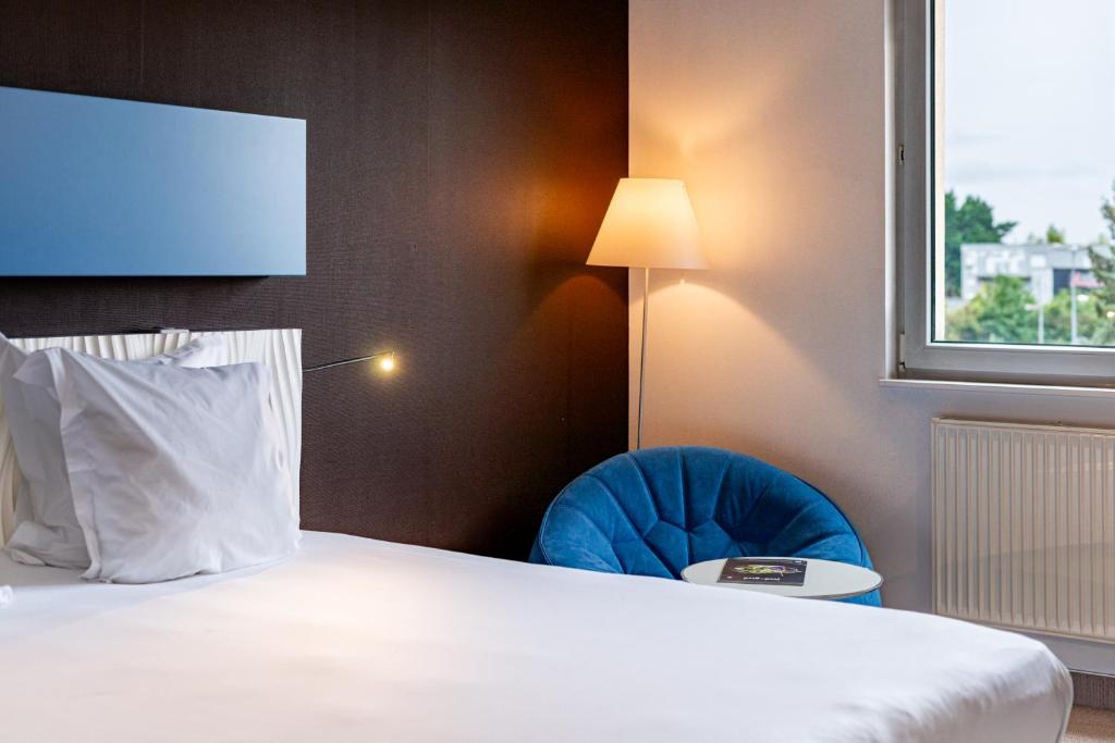 Postel nebo postele na pokoji v ubytování Hotel L'Europe