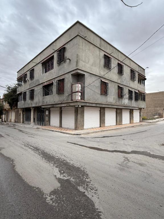 an old building sitting on the side of a street at Villa SAAD in Khenchela