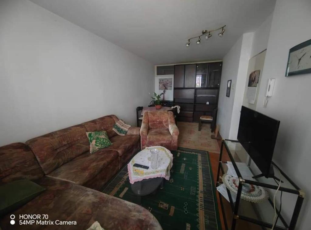 a living room with a couch and a tv at Apartment Korzo in Bjelovar